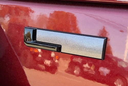 Gloss Black "L" Liftgate Badge from the 2021-2025 Grand Cherokee L